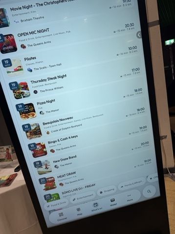 A Mapzest kiosk showing a list of upcoming events with dates, times and venues