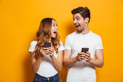Couple laughing with phones