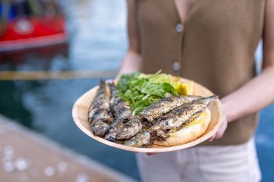 A plate of charcoal-grilled sardines with salad and bread, held harbour-side at the South West Sardine Festival